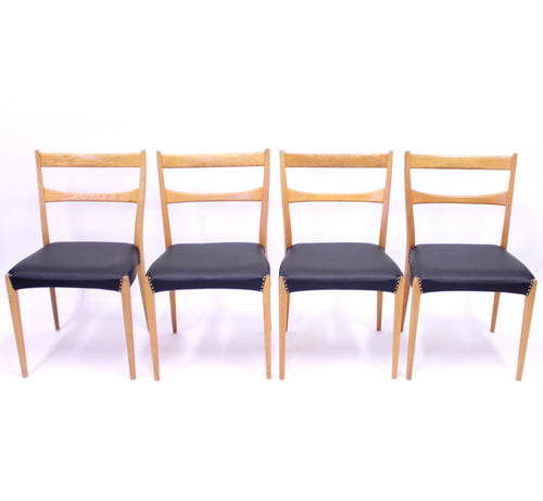 Scandinavian oak dining chairs with black leather seats, 1950s